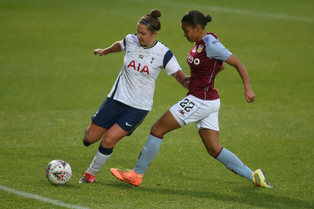 Girls playing football on a field

Description automatically generated