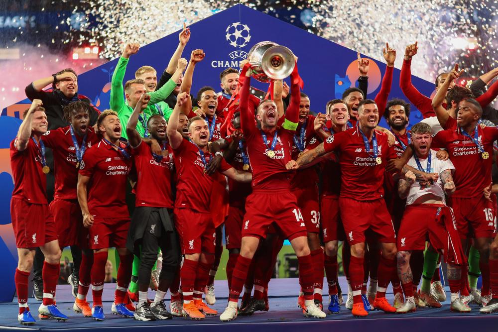 A group of people holding a trophy
