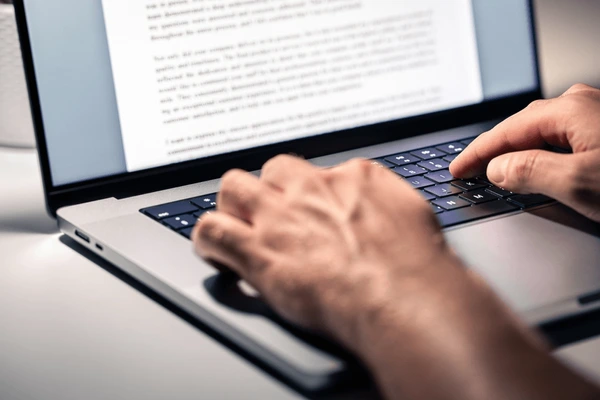 Man is writing on the laptop 