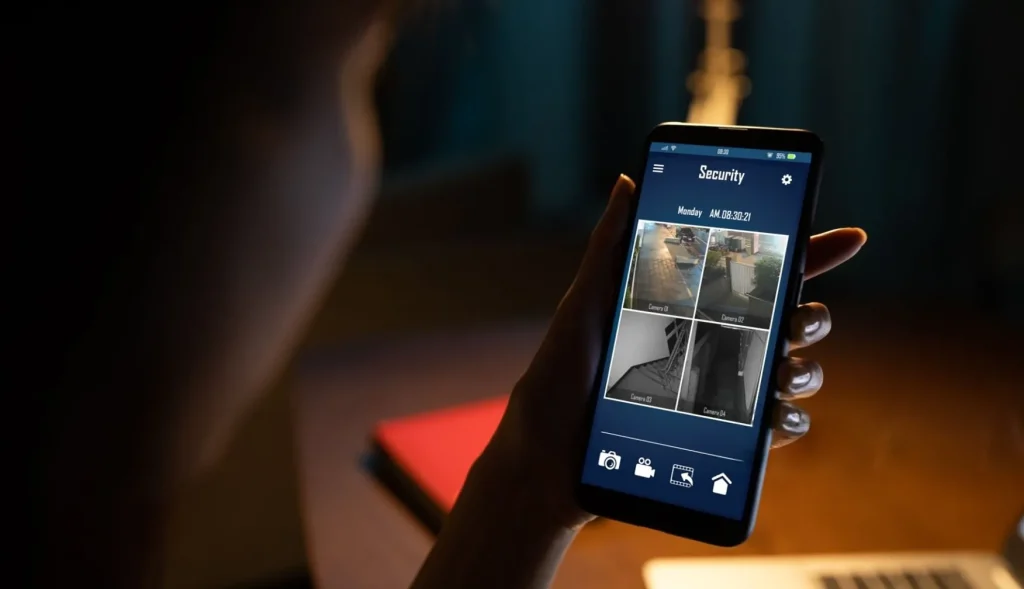 A home owner watching her home security cameras on a smartphone