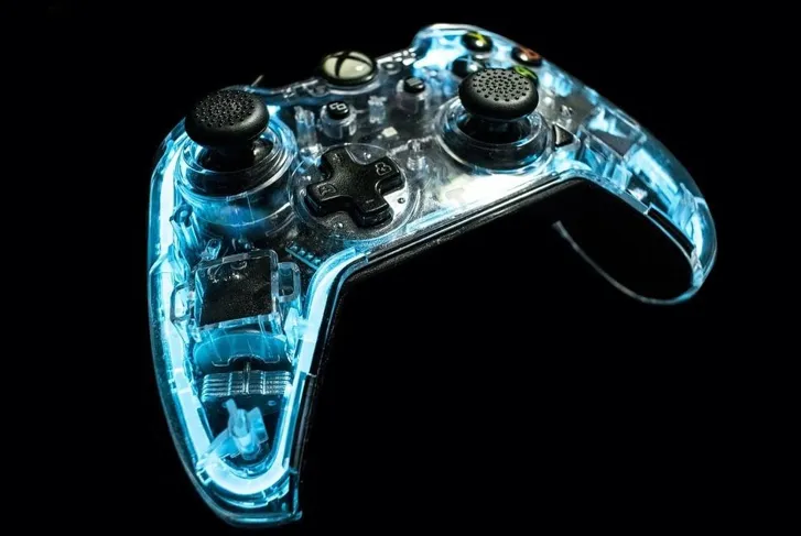 Close-up on a transparent blue Xbox controller on a black background