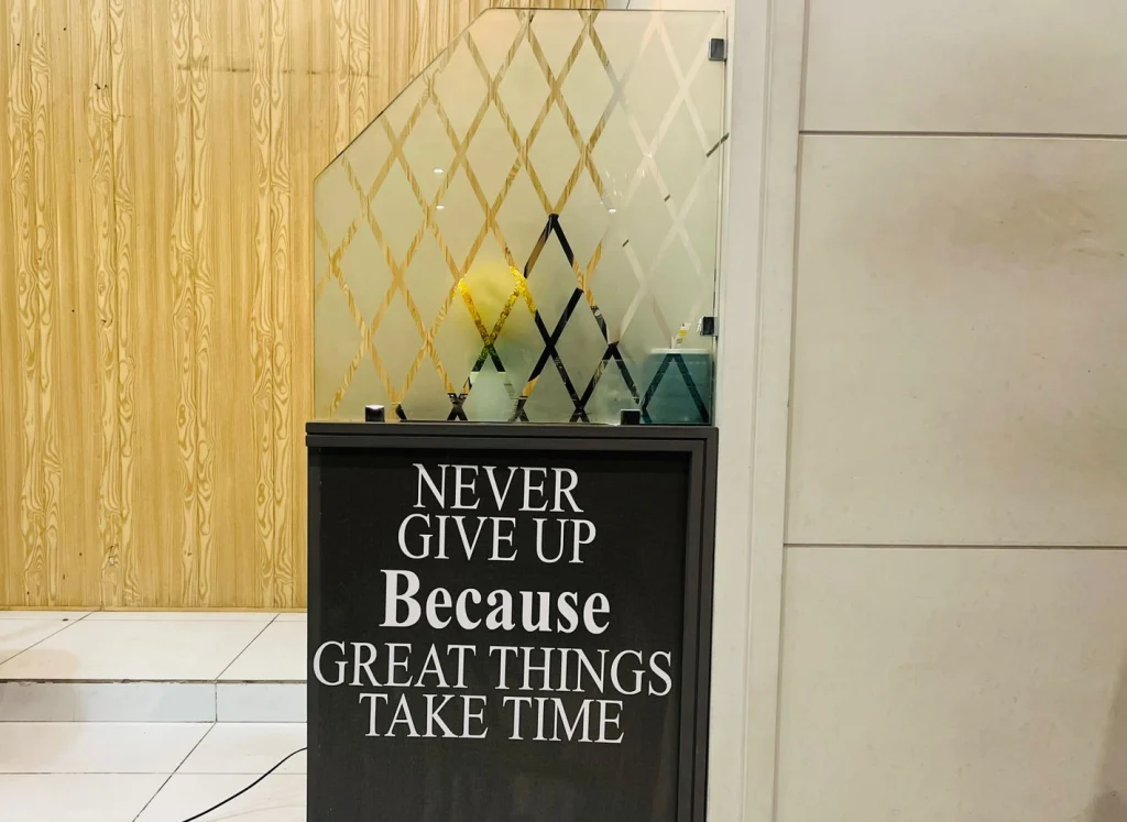 My remote setup glass with motivational Quote on side wall of desk