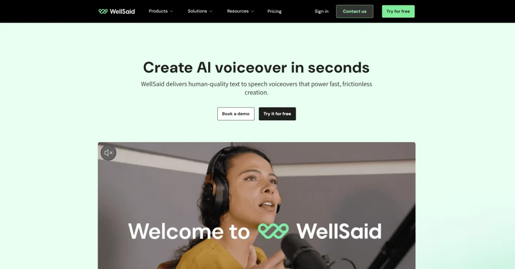 The WellSaid Labs homepage with a soft mint-green background. The headline reads "Create AI voiceover in seconds." The page features a video preview of a person in a recording studio with the text "Welcome to WellSaid," emphasizing "human-quality" text-to-speech for frictionless creation.