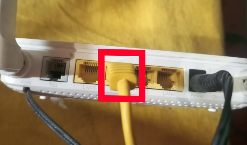 Plug one end of the Ethernet cable into an available LAN port on your router or switch.
