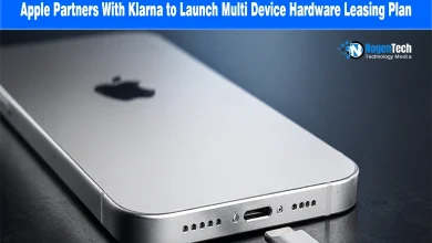 Close-up of a silver iPhone displaying its bottom charging port and speaker grilles.