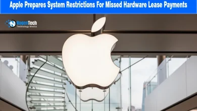 Illuminated Apple logo hanging inside a modern Apple Store above a glass staircase.