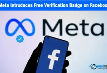 Smartphone showing the Facebook logo held in front of a screen displaying Meta branding and a blue verification badge icon.