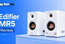 Pair of white Edifier MR5 studio monitor speakers with copper accents on a desk.