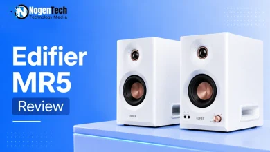 Pair of white Edifier MR5 studio monitor speakers with copper accents on a desk.