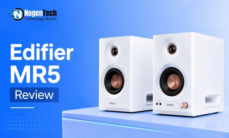 Pair of white Edifier MR5 studio monitor speakers with copper accents on a desk.