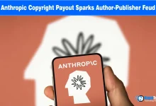 Hand holding a smartphone displaying the Anthropic logo over a warm background.