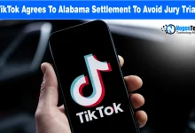 Smartphone held in hand displaying the TikTok logo on screen.