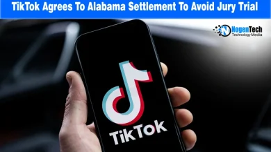 Smartphone held in hand displaying the TikTok logo on screen.
