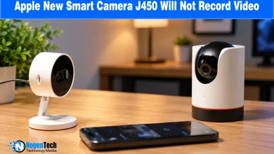 Two white smart home security cameras and a smartphone resting on a wooden tabletop.