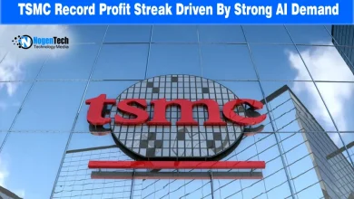 Red TSMC company logo mounted on a glass high-rise building exterior under a bright blue sky.
