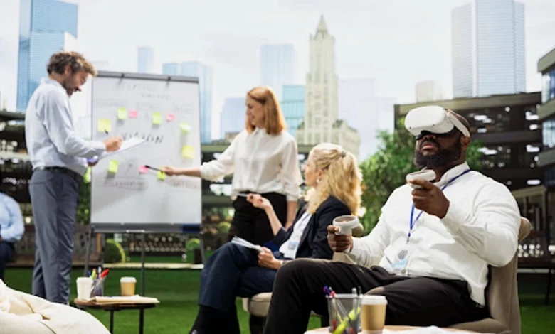 Business team collaborating in an outdoor workspace while a colleague wears a VR headset and holds controllers.